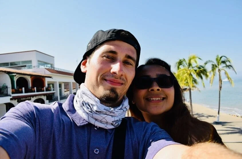 alex white-gomez, founder of mexicotravelbuddy.com with his mexican wife on the beach