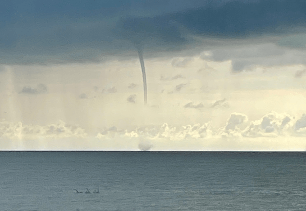 Low-season weather in the mid-afternoon—a cyclone forming over the ocean.