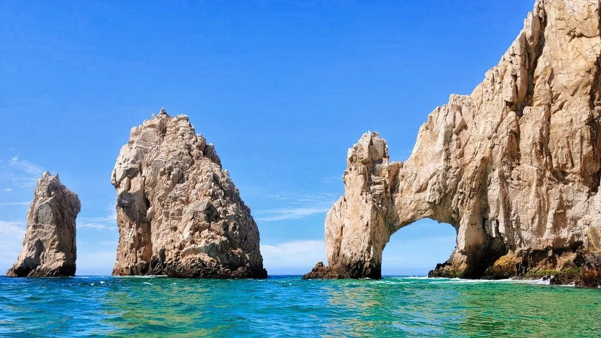brown rock formation on blue sea in Baja California under blue sky during daytime